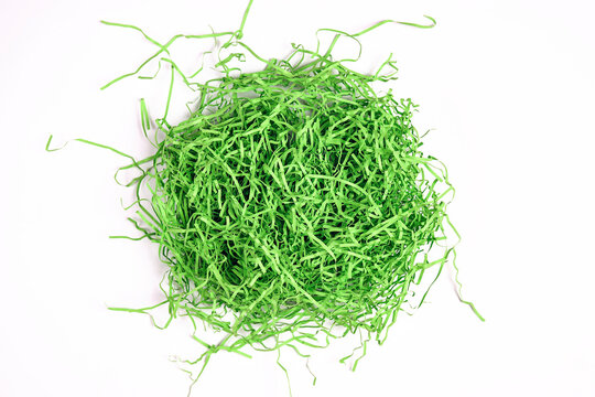 Green Shredded Paper Packaging Material On White Background.