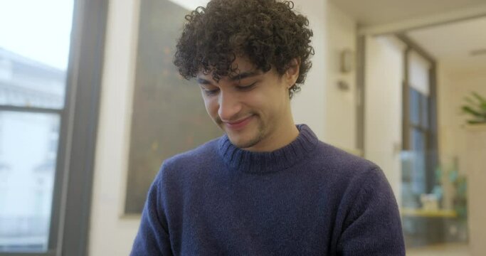 Close-up of smiling man text messaging