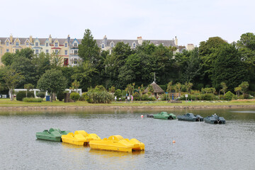 Fototapeta premium Pedalo or pedal boats moored in the centre of Lake Mooragh in Ramsey on the Isle of Man.