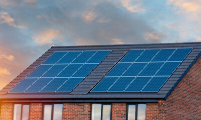 Photovoltaic solar panels on the roof of new house. Roof with solar panels