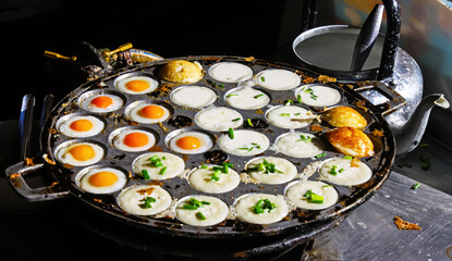 Traditional thai street food breakfast snack with fried quail eggs (Khai Nok Gatta) , coconut pudding pancakes (Kanom Krok) in takoyaki pan - Thailand - obrazy, fototapety, plakaty