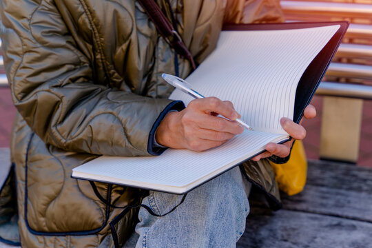 Portrait Of Happy Older Asian Woman  Writing On A Notebook  Outside It's Never Too Late To Earn A Degree Concept