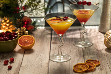 Festive Mimosa cocktails garnished with spiced dried oranges and cranberries.