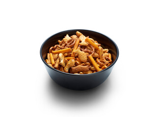 A black ceramic bowl of crispy savoury cracker party food snacks isolated against a transparent background.