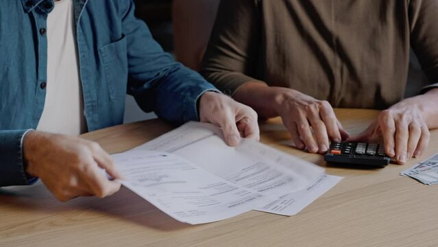 Elderly people read utility bills and calculate amount sums