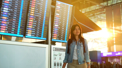 Asian traveler woman walking in airport terminal.