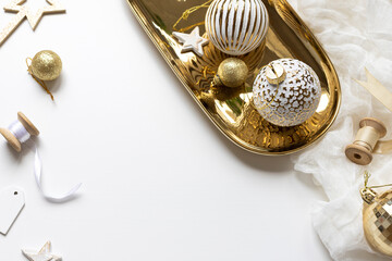 Christmas celebration concept composition with golden and white decoration on the table. Close up....
