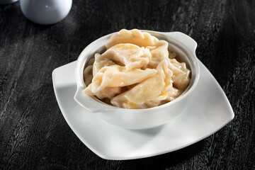 close up view of plate with dumplings  on grery background. - 544899371