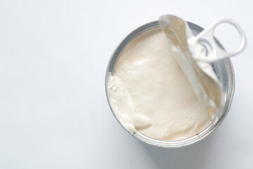 top view of milk cream in a tin container on table 