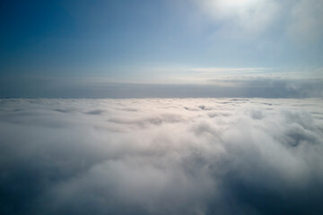 Aerial view from high altitude of earth covered with puffy rainy clouds forming before rainstorm