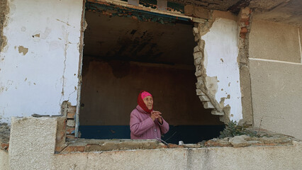 Grandma is praying. Woman praying for an end to the war. War. War in Ukraine. Grandmother prays in...