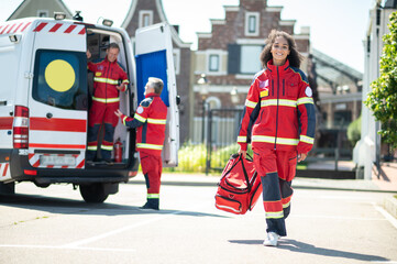 Cheerful young paramedic arriving for her day shift