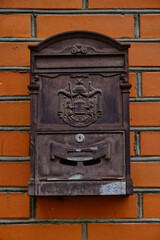 Old vintage mailbox on brick wall.
