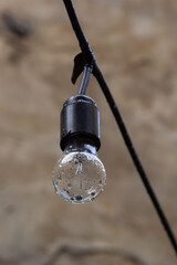 electric light bulb on the background of the wall. Street decor. Concept of electricity saving