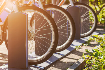 Electric Bikes on Charging Station Close up in Germany. Bicycles for Rent Service. e bike or e-bike...