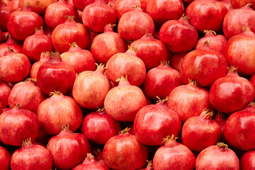 Pomegranate fruits food background. Heap of fresh pomegranates