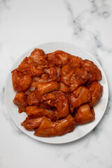 Marinating meat with spices and onion on plate