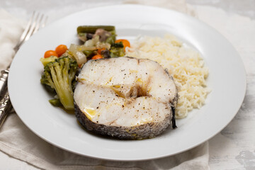 baked vegetables with boiled fish on white plate