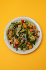 Mixed boiled vegetables on light brown dish