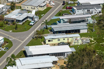 Badly damaged mobile homes after hurricane Ian in Florida residential area. Consequences of natural...