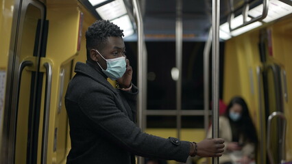 Black man commuter removing face mask at metro subway. end of pandemic concept