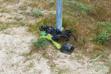 Achtlos weggeworfene Hundekotbeutel an der Ostsee am Strand