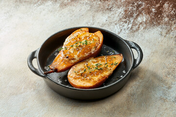 Baked pear with blue cheese and caramel plate. Close-up, selective focus.