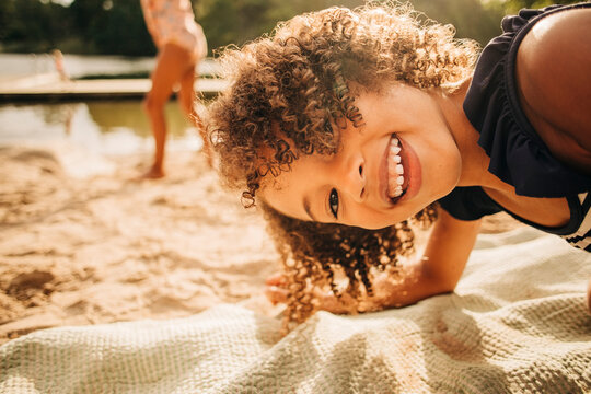 Portrait of playful girl with curly hair enjoying on vacation