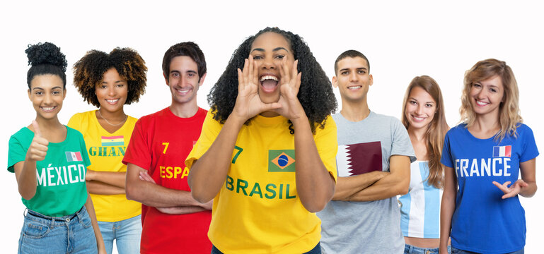 Cheering soccer fan from Brazil with supporters from Spain Ghana Mexico Qatar Argentina and France