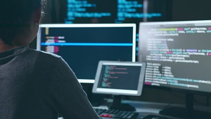 Young Asian woman, developer programmer, software engineer, IT support, working hard at night overtime on computer to check coding in bugging system