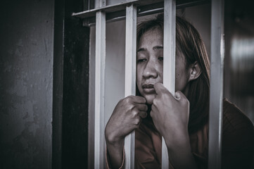 Hands of women desperate to catch the iron prison,prisoner concept,thailand people,Hope to be...