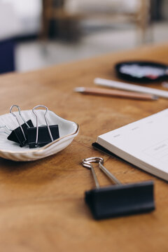 Side View Of Office Supplies On A Wooden Table