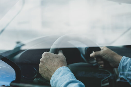 Cropped Hands Of Person Holding Steering Wheel