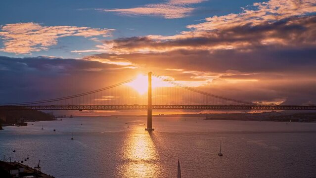 Beautiful sunset over Bridge of 25th April, Lisbon, Portugal. Famous