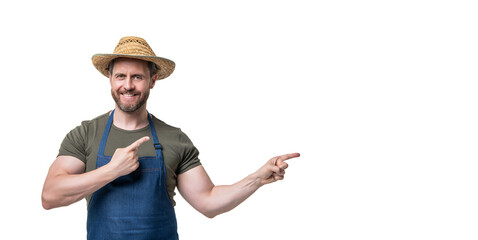 caucasian man in hat and apron isolated on white background. pointing finger on copy space