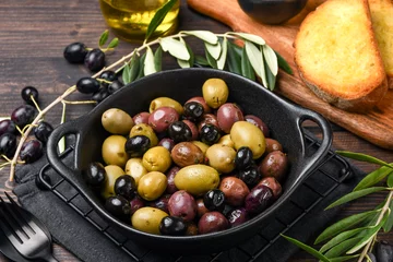 Fototapeten healthy food salad different green and black olives with olive oil and herbs © KEA