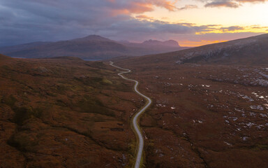 Winding roads and a Scottish Road Trip through the Highlands at sunset.  North Coast 500