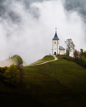 Spooky Church on Hill with Clouds rising behind it.  Minimalistic, Halloween in Slovenia. 