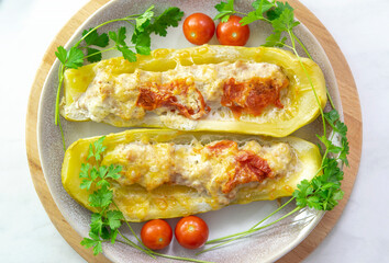 Stuffed zucchini of minced chicken, turkey meat. Zucchini baked in the oven with cheese. Healthy dinner for the whole family