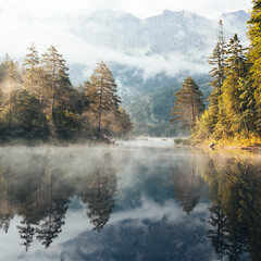 Beautiful misty morning on Eibsee, Oberammergau.  Bavaria, Germany.  Zugspitze Mountain in background 