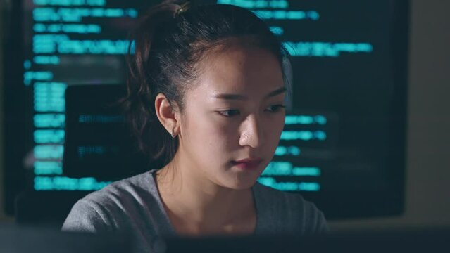 Young Asian woman, developer programmer, software engineer, IT support, working hard at night overtime on computer to check coding in bugging system and running program fail and feeling stress.