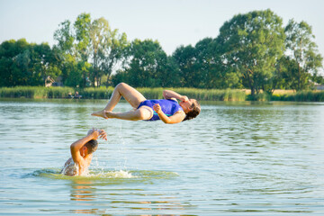 On a bright sunny day, brother and sister bathe on the river.
