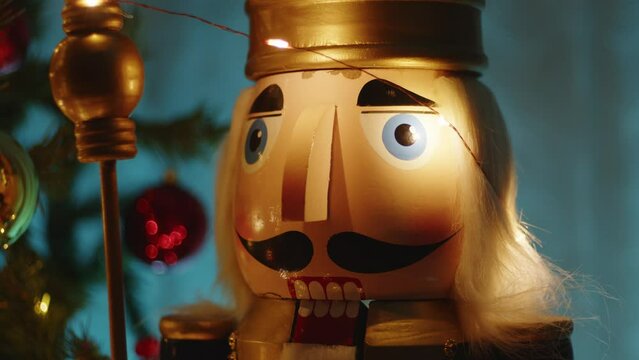 Christmas tree with golden and red balls in the night and nutcracker