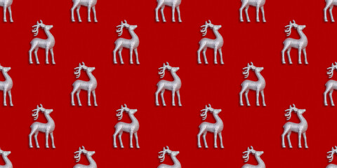 Seamless New Year and Christmas pattern with silver deers on a red background