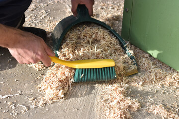 Dustpan sweeping wood chips
