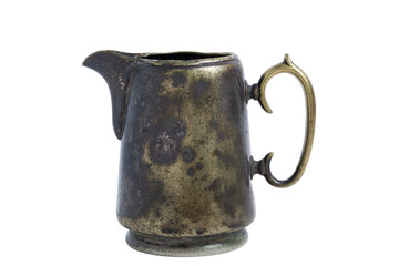 Vintage brass creamer with dents and scratches isolated on a white background.