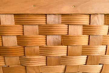 Close up of woven wooden basket. Textured wooden patterned background. Abstract natural colored wooden backdrop
