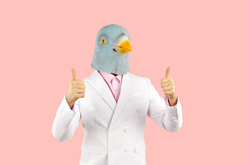 Content man with funny bird face shows thumbs up with both hands. Surreal shot of supportive guy...