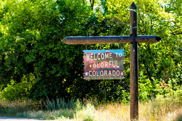  Welcome to colorful Colorado sign closeup view from road highway with border to Utah in summer in Bedrock, USA