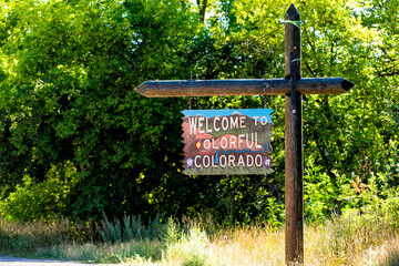  Welcome to colorful Colorado sign closeup view from road highway with border to Utah in summer in...